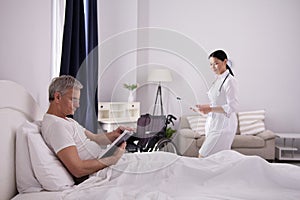 Disabled man reading in bed.