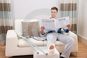 Disabled man reading newspaper