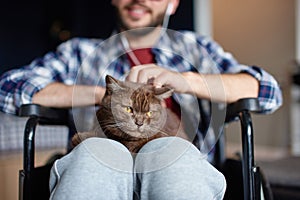 Disabled man rehabilitation at home with cat