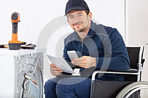 disabled man repairing washing machine