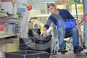 Disabled man shopping in hardware store