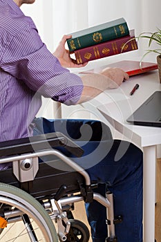 A disabled man sitting and learns