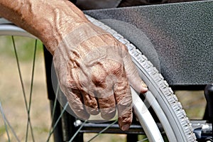 A disabled man is sitting in a wheelchair ,Holds his hands on the wheel. Handicap people Concept
