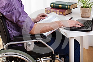 Disabled man studying at home photo