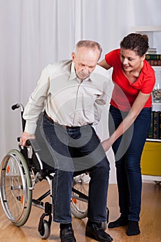 Disabled man trying to stand up