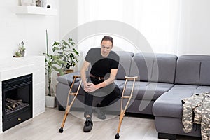 Disabled Man Using Crutches At Home