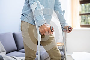 Disabled Man Using Crutches To Walk