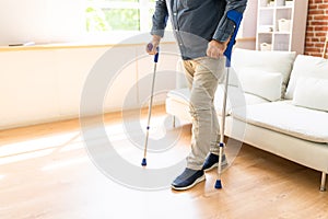 Disabled Man Using Crutches To Walk