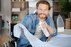 disabled man using spray on shirthe ironing