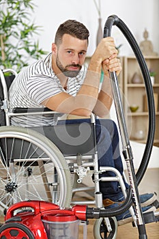 disabled man using vacuum cleaner