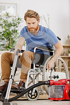 disabled man using vacuum cleaner