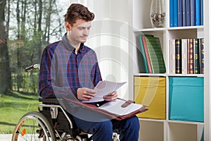 Disabled man viewing documents