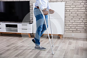 Disabled Man Walking With Crutches