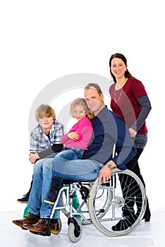 Disabled man in weelchair with his family