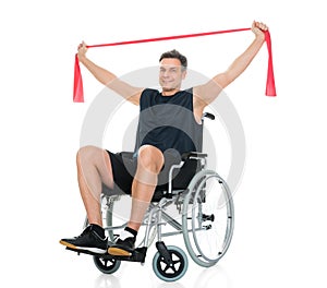 Disabled man on wheelchair exercising with resistance band