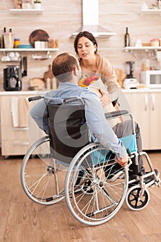 Disabled man in wheelchair with groceries