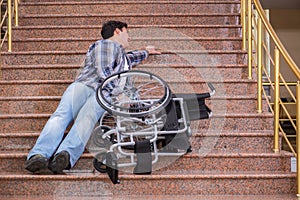 The disabled man on wheelchair having trouble with stairs