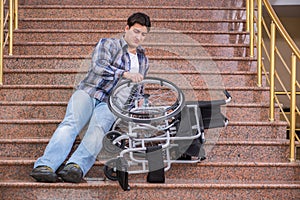 The disabled man on wheelchair having trouble with stairs