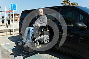 Disabled man on wheelchair lift
