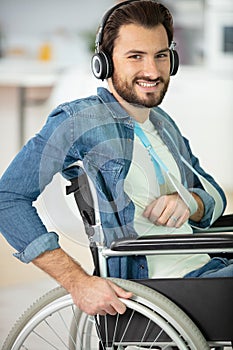 disabled man on wheelchair listening music with earphones photo