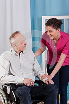 Disabled man on wheelchair and nurse