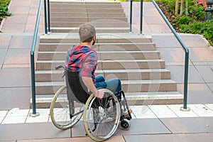 Disabled man in wheelchair on road