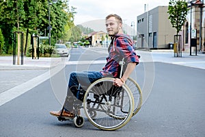 Disabled man in wheelchair on road