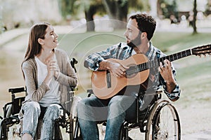 Disabled Man on Wheelchairs Playing Guitar in Park