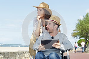 disabled man with wife on beach