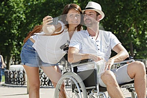 disabled man with wife having fun taking selfie photos