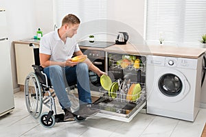 Disabled man working in kitchen