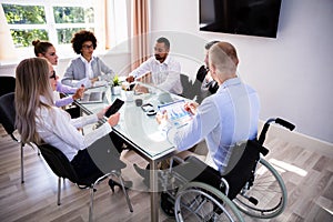 Disabled Manager Sitting With His Colleagues