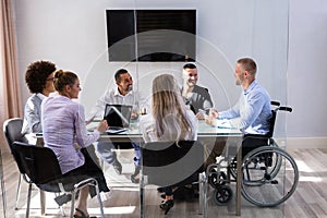 Disabled Manager Sitting With His Colleagues photo