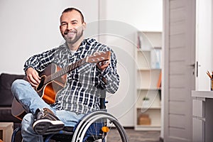 Disabled musician tuning his instrument