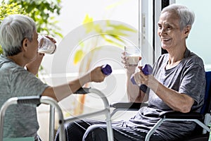 Disabled old elderly people in a wheelchair drinking beverages,dietary supplements,healthy senior woman holding glass of fresh