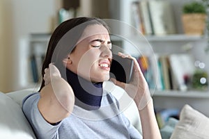 Disabled painful woman with neck brace talking on phone