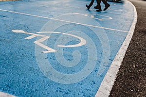 Disabled parking sign painted on the floor, example of integration of people with less mobility