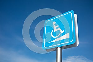 Disabled parking signage with blue sky
