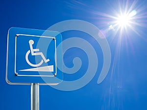 Disabled parking space and wheelchair way sign and symbols on a pole warning motorists