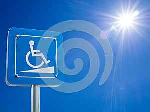 Disabled parking space and wheelchair way sign and symbols on a pole warning motorists photo