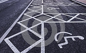 Disabled parking spaces painted on a tarmac road