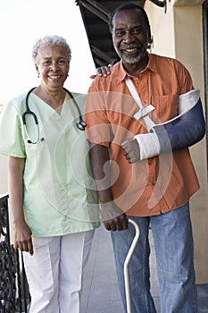 Disabled Patient Standing With Doctor