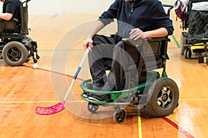 Disabled People on an electric wheelchair playing sports, powerchair hockey. IWAS - International wheelchair and amputee