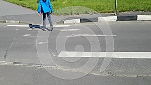 Disabled person crossing a pedestrian crossing. The body sways, it wobbles. The man walks on tiptoe. He has cerebral palsy.