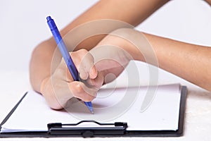 Disabled person hand without fingers since childhood brith, using pen to write word sentence on paper note. Woman use short