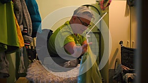 A disabled person pulls out a cat food bag.