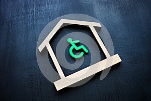 Disabled Person sign and house as symbol of real estate. Accessible home ownership rights.