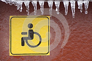 Disabled person sign on the house. Road icing and danger to the movement of people