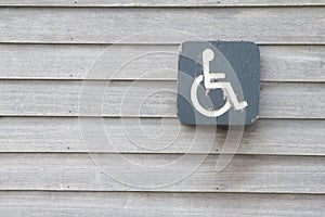 Disabled person sign on old wood wall, used as a background