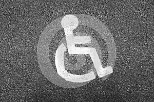 Disabled person sign. painted with white paint on the pavement